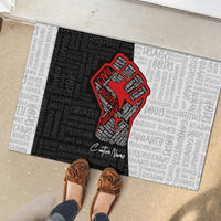 Personalized civil rights doormat with red justice fist graphic and monochrome word pattern