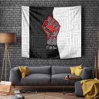 Wall-hanging tapestry with black-and-white typography print and red raised fist graphic