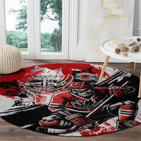 Red, black, and white round hockey area rug featuring goalie skull and hockey stick artwork