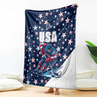 USA ice hockey blanket draped on bed, navy with USA text, stars, and goalie illustration