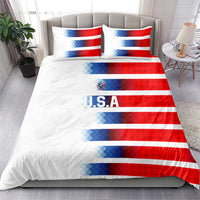 White bedding set with red-and-blue diagonal USA stripes, U.S.A text, and two pillows