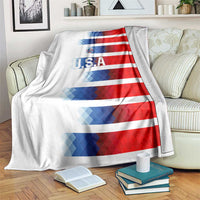 USA soccer blanket draped over couch, red and blue striped design with U.S.A logo