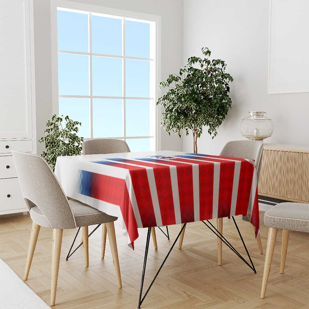 USA soccer tablecloth over dining table; red and white stripes with blue crest detail