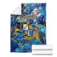 Blue Anguilla blanket with sea turtle artwork, sold as folded and rolled set.