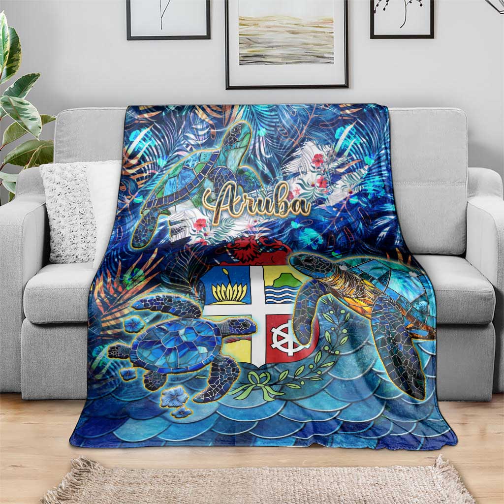 Blue sea turtle tropical throw blanket with Aruba logo, draped on sofa