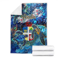 Blue sea turtle tropical blanket with Aruba text, shown with folded white towels