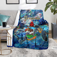 Blue sea turtle tropical throw blanket with Bermuda lettering, draped over furniture