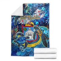 Blue sea turtle tropical blanket folded, showing Sint Maarten crest and PRO GREDENS