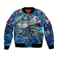 Unisex blue bomber jacket with sea turtle tropical graphic, black ribbed trim and zipper