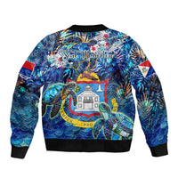 Unisex blue bomber jacket, back sea turtle tropical pattern with black ribbed hem and cuffs