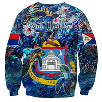 Blue crewneck sweatshirt featuring sea turtles over ocean scale pattern, long sleeves.