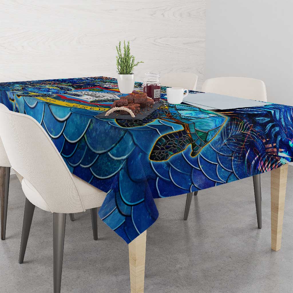 Blue wave-scale tablecloth featuring sea turtle motifs, draped over dining table corners