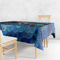 Blue sea turtle tablecloth hanging over table front, scales pattern with colorful accents