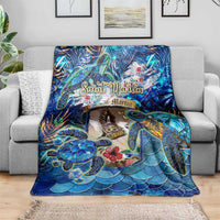 Blue sea turtle tropical blanket draped on sofa, wave scallop scales and floral accents