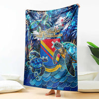 Blue sea turtle tropical pattern blanket draped over sofa, bold rainbow stripe design
