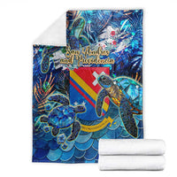 Folded blue sea turtle tropical pattern blanket with colorful stripes and turtle graphics