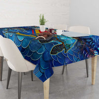 Blue sea turtle tablecloth draped over dining table, showing wave-scale pattern.