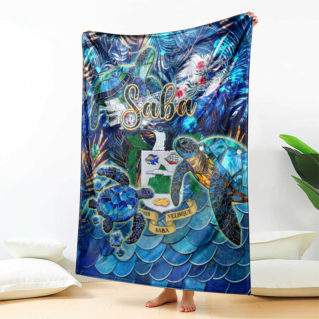 Folded blue sea turtle blanket with tropical print and Saba lettering