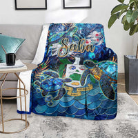 Blue sea turtle blanket on floor with tropical Saba print