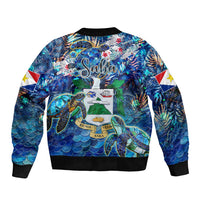 Unisex blue bomber jacket with sea turtle tropical print, crew neckline, black rib trim
