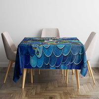 Blue sea turtle tablecloth with scalloped wave pattern, on dining table with chairs