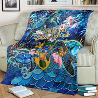 Blue sea turtle tropical blanket showing “Turks and Caicos Islands” text over ocean-scale pattern