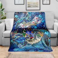 Blue sea turtle tropical print blanket spread across a couch, full design with turtles and waves