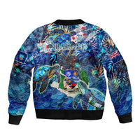 Unisex blue bomber jacket with sea turtle tropical print, back graphic with logo, black ribbed hem