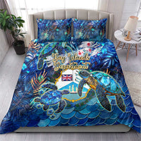Blue tropical bedding set featuring sea turtles on a wave scale pattern, with two pillows