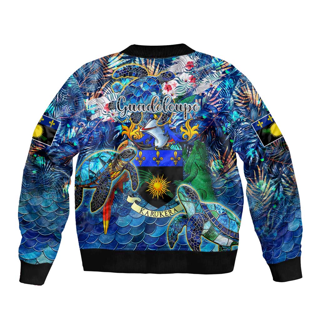 Unisex blue bomber jacket with sea turtle tropical print, black ribbed hem and cuffs