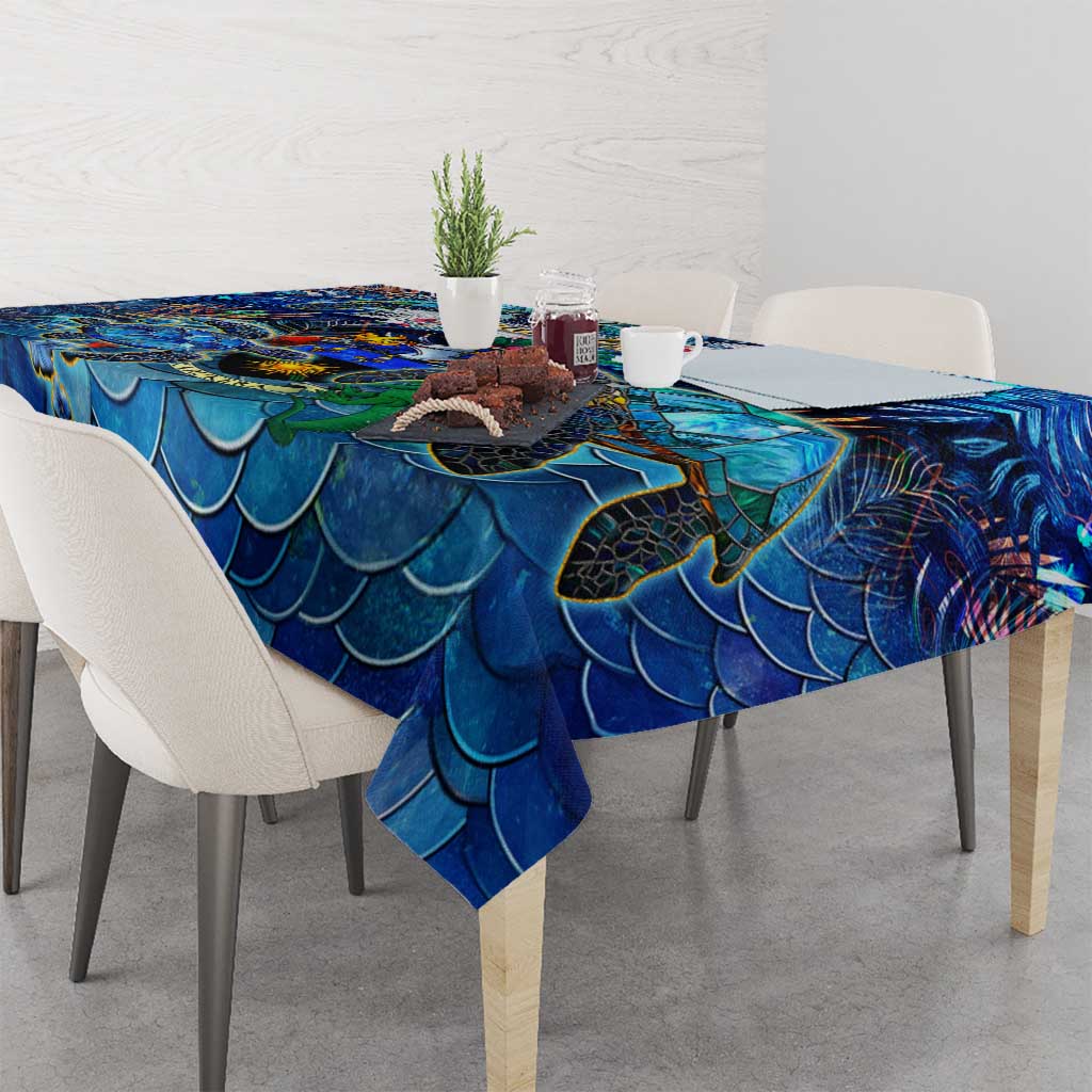 Blue sea turtle tablecloth with scalloped fin scale pattern draped over dining table