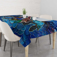 Blue sea turtle tablecloth with scalloped fin scale pattern draped over dining table