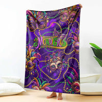 Purple Mardi Gras glitter art blanket featuring decorative masquerade mask artwork, on floor