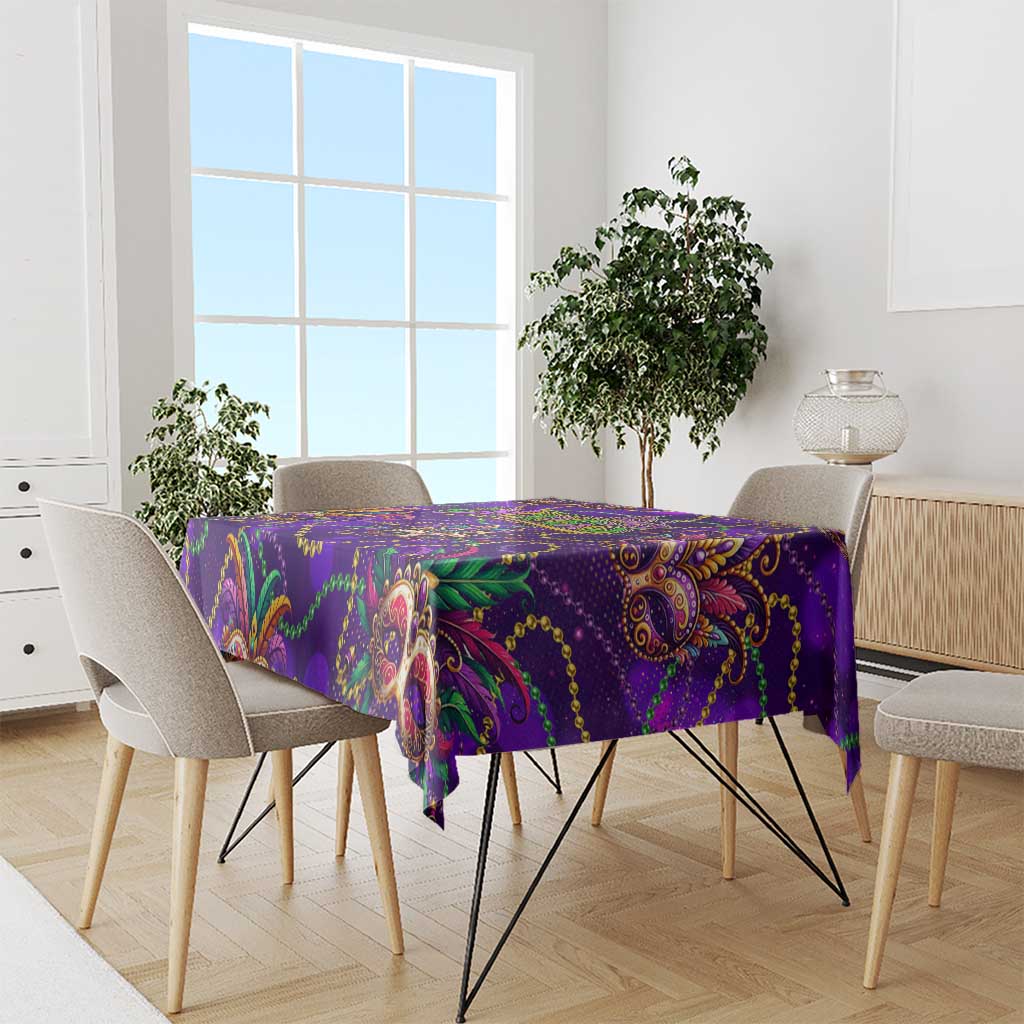 Purple glitter tablecloth draped on dining table, with mask and paisley pattern