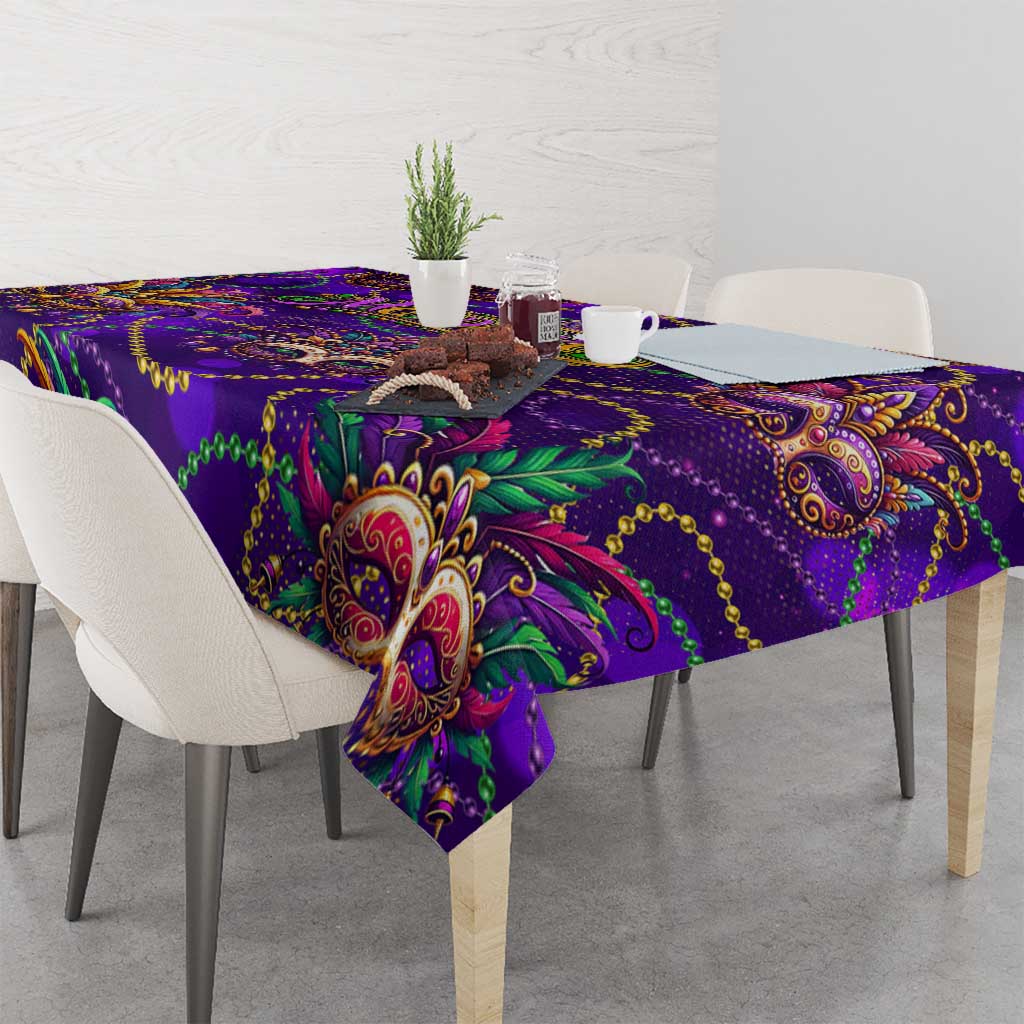 Purple glitter tablecloth with ornate mask and scrolling paisley motifs, corner view