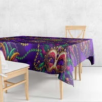 Purple glitter tablecloth with mask medallion and chain-like border, hanging edge view