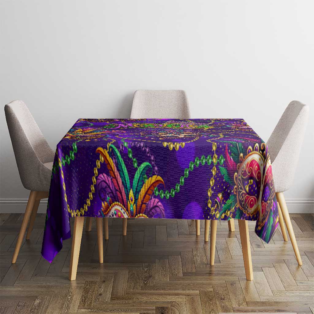 Purple glitter tablecloth on dining table with ornate mask and paisley print