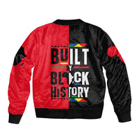 Unisex bomber jacket back with red and black panels, large Built by Black History text graphic