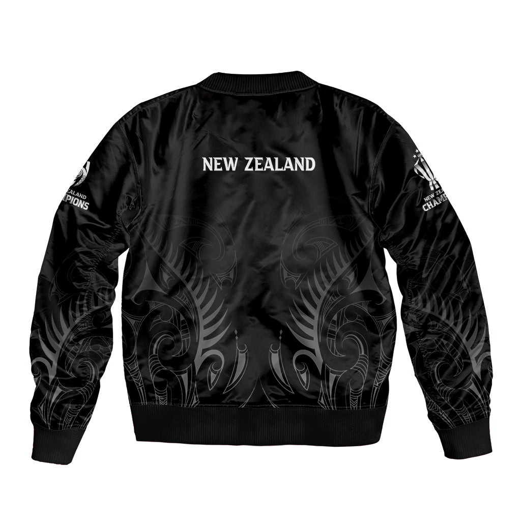 Black bomber jacket with “NEW ZEALAND” back print, ribbed hem, and sleeve graphics