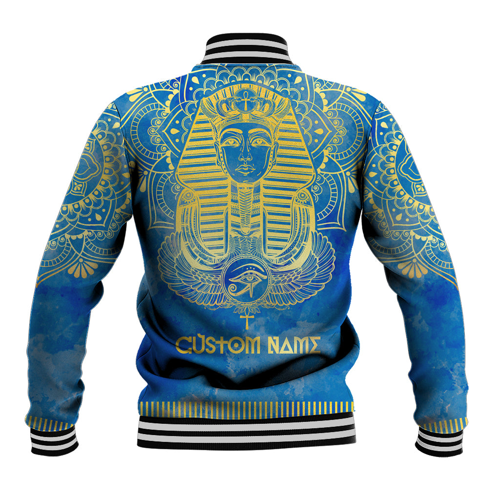 Blue baseball jacket back with gold pharaoh artwork and Custom Name text, striped rib trim