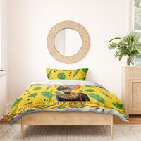 Yellow duvet cover and pillowcases with green tropical leaves and African woman portrait design