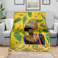 Yellow throw blanket with centered woman portrait, green foliage, and zigzag border