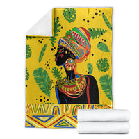 Yellow tropical blanket with woman portrait, leafy background, and zigzag bottom border