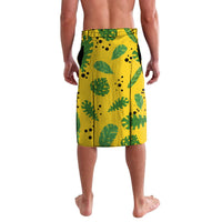 Yellow wrap lavalava skirt with green leaf pattern, small dot accents, bordered hem