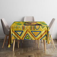 Yellow tropical tablecloth on table with triangle and stripe patterns in blue and green