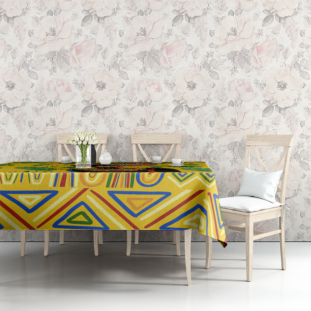 Yellow tropical tablecloth with blue geometric and green leaf motifs on dining table