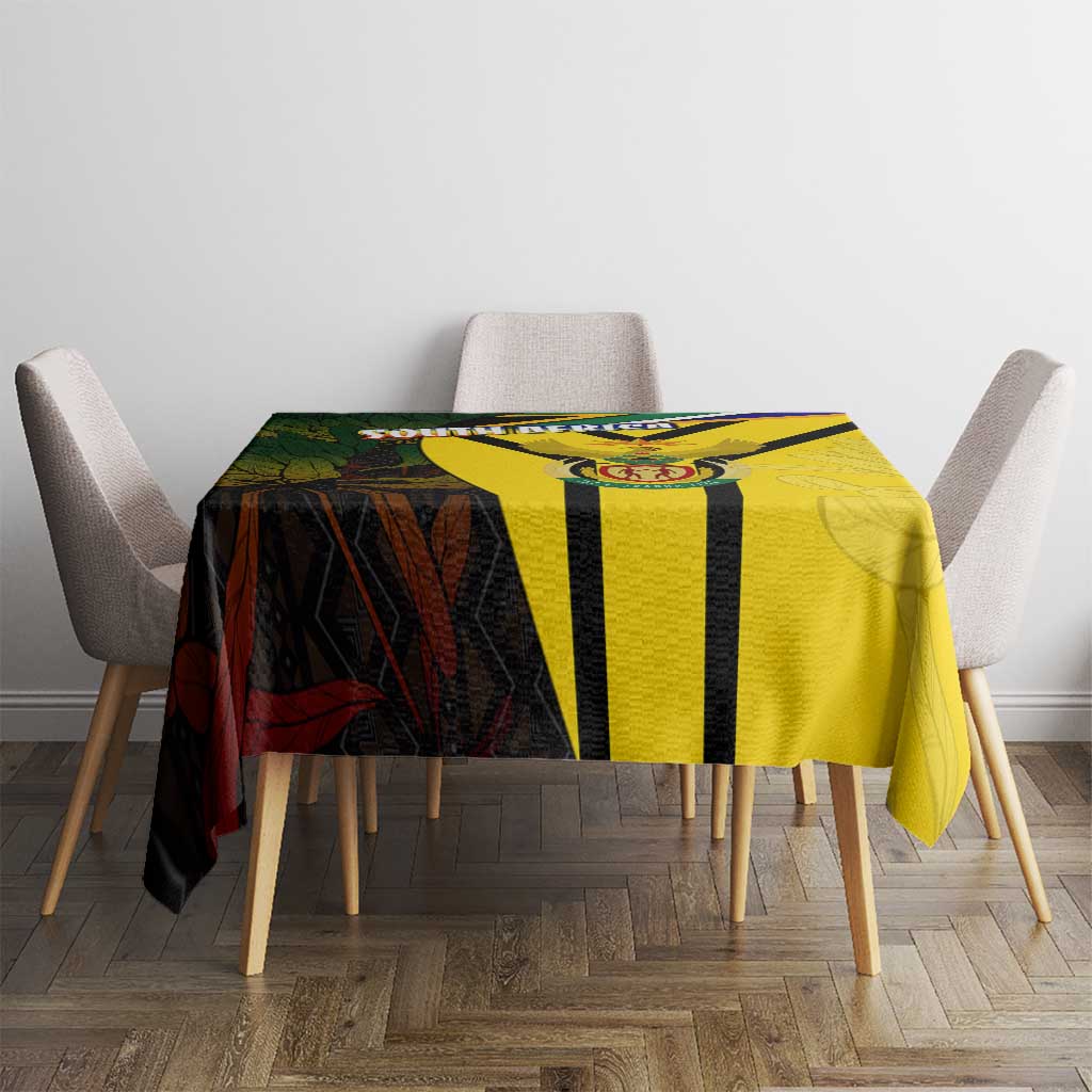 South Africa coat of arms tablecloth on dining table with yellow, black, and red emblem print