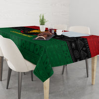 Tablecloth on dining table with green geometric center and black patterned sides