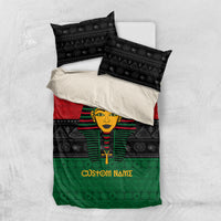 Bedding set flat lay: black pillowcases and pharaoh duvet in red, green, 'Custom Namz'