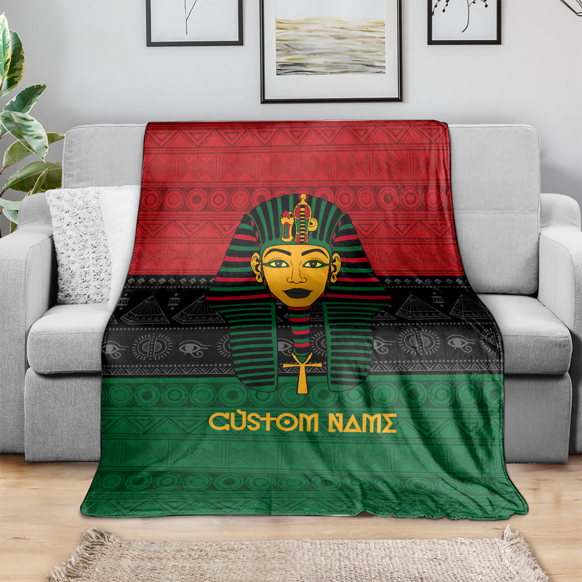 Personalized pharaoh throw blanket draped on a sofa, red, black, and green geometric pattern